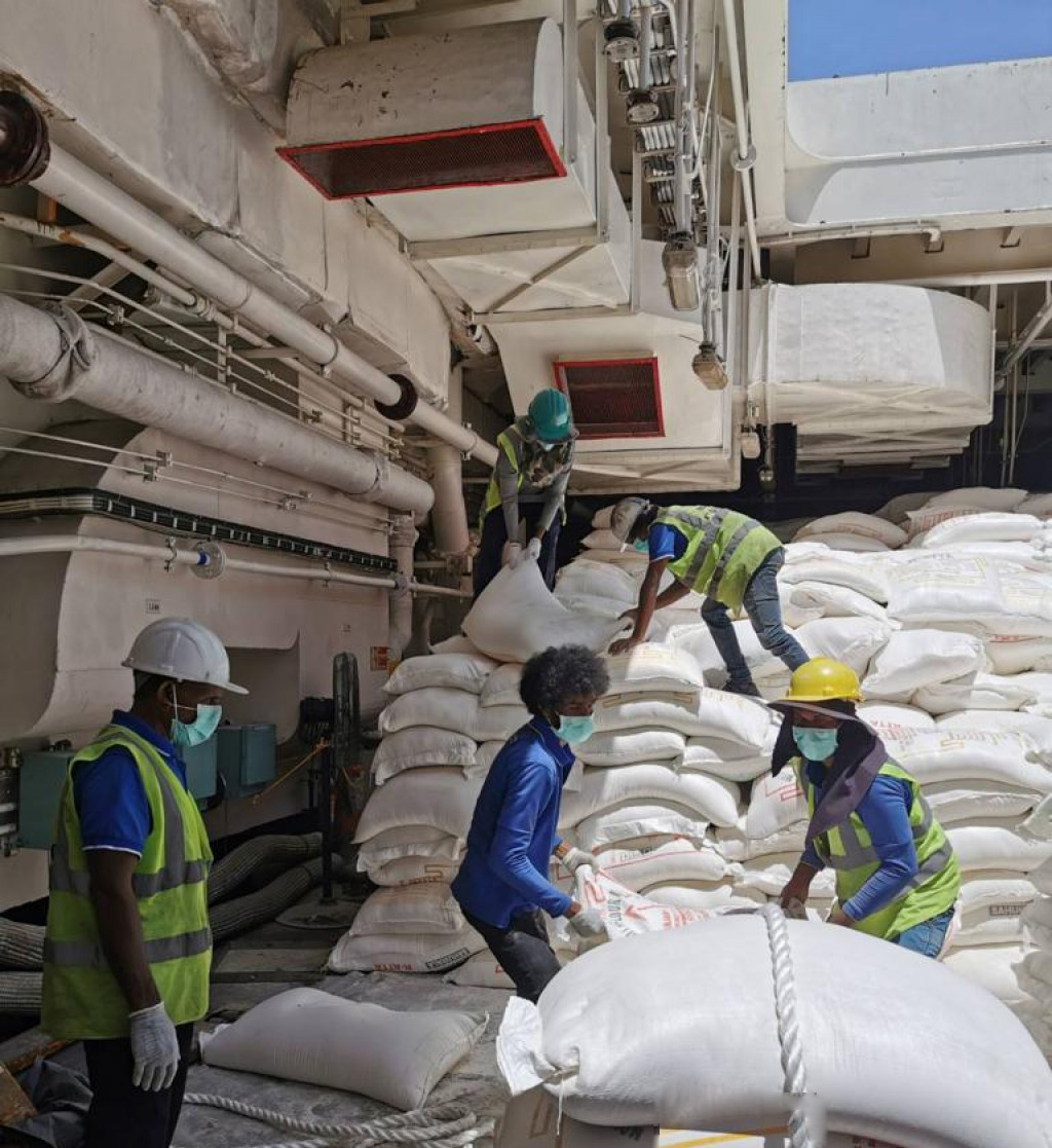 Workers handling agricultural commodities in warehouse